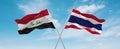 two crossed flags thailand and Iraq waving in wind at cloudy sky. Concept of relationship, dialog, travelling between two