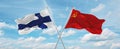 two crossed flags ussr and finland waving in wind at cloudy sky. Concept of relationship, dialog, travelling between two countries