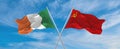 two crossed flags ussr and Ireland waving in wind at cloudy sky. Concept of relationship, dialog, travelling between two countries