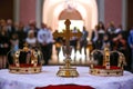 Two crowns and cross on white table prepared for wedding. Orthodox church wedding accessories Royalty Free Stock Photo