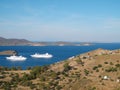 Two cruise ships moving into the port city of Skala in Patmos, Greece