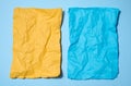 Two crumpled sheets of paper, yellow and blue on a blue background, space for an inscription Royalty Free Stock Photo