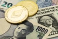 Two cryptocurrency coins laid on top of Yen, US Dollar and Euro banknotes Royalty Free Stock Photo