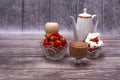 Two crystal vases with ripe strawberries, two glasses cocktail, white teapot stand on wooden table. Royalty Free Stock Photo