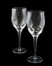 Two crystal wine glasses on dark background, with