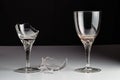 Two crystal wine glasses, new and broken, and a shard of glass Royalty Free Stock Photo