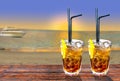Two Cuba libre exotic tasty cocktail with beautiful sunset and b