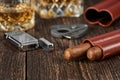 Two Cuban cigars, a cutter and a lighter in a leather case on an old brown table Royalty Free Stock Photo