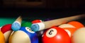 Two cues lie on a triangle with billiard balls on the pool table Royalty Free Stock Photo