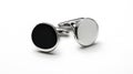 Two cufflinks, one black and one white, are sitting on a white background Royalty Free Stock Photo