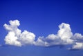 Two cumulus clouds on a blue sky Royalty Free Stock Photo