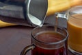 Two cup of coffee. Pouring milk in coffee cup Royalty Free Stock Photo