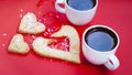 Two cups of black coffee, red background. Hot coffee in white cups and heart shaped cookie, colorful bright background Royalty Free Stock Photo