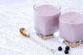 Two cups of blueberry yogurt and spoon on the table Royalty Free Stock Photo