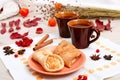 Two cups of brown clay with tea are on a white linen napkin. Butter cookies with fruit jam and cake with cottage cheese are on a r Royalty Free Stock Photo