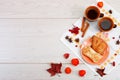 Two cups of brown clay with tea are on a white linen napkin. Butter cookies with fruit jam and cake with cottage cheese are on a r Royalty Free Stock Photo