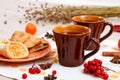 Two cups of brown clay with tea are on a white linen napkin. Butter cookies with fruit jam and cake with cottage cheese are on a r Royalty Free Stock Photo