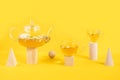 Two cups of camomile tea, transparent teapot on wood geometric shape, yellow background. Creative concept Natural