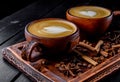 Two cups of cappuccino coffee with latte art on dark background Royalty Free Stock Photo