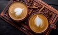 Two cups of cappuccino coffee with latte art on dark background Royalty Free Stock Photo