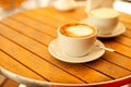 Two cups with cappuccino (hot coffee with milk) Royalty Free Stock Photo