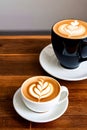 Two cups of cappuccino on a wooden table generated by ai Royalty Free Stock Photo