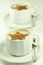 Two cups of capuccino on white background