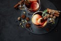 Two cups of Christmas mulled wine or gluhwein with spices and lemon slices on dark wooden background. Christmas or New Year Royalty Free Stock Photo