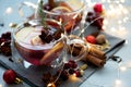 Two cups of Christmas mulled wine or gluhwein with spices and lemon slices on gray wooden background with defocused lights. Royalty Free Stock Photo
