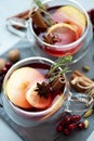 Two cups of Christmas mulled wine or gluhwein with spices and lemon slices on gray wooden background. Christmas or New Year Royalty Free Stock Photo