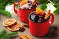 Two cups of christmas mulled wine or gluhwein with spices and orange slices on rustic table top view. Traditional drink Royalty Free Stock Photo