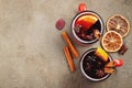 Two cups of christmas mulled wine or gluhwein with spices and orange slices on rustic table top view. Traditional drink on winter Royalty Free Stock Photo