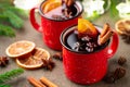 Two cups of christmas mulled wine or gluhwein with spices and orange slices on rustic table top view. Traditional drink on winter Royalty Free Stock Photo