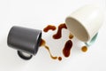 two cups of coffee with brown spill on white background Royalty Free Stock Photo