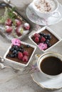 Two cups of coffee, chocolate desserts and strawberries, vintage cutlery Royalty Free Stock Photo