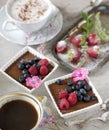 Two cups of coffee, chocolate desserts and strawberries, vintage cutlery Royalty Free Stock Photo