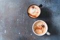 Two cups of coffee with crema, cinnamon and badian on dark background Royalty Free Stock Photo