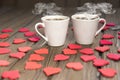 Two cups of coffee, figures of hearts, on a wooden table. Royalty Free Stock Photo