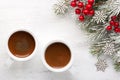 Two cups of coffee and fir branch with Christmas decorations on old wooden shabby background