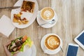 Two cups of coffee, friendly atmosphere. Chicken sandwich, Cup of coffee and smartphone on the table Royalty Free Stock Photo