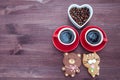 Two cups of coffee, a heart with coffee beans and biscuits in the form of animals. Royalty Free Stock Photo