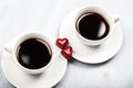 Two cups of coffee and heart shaped sweets
