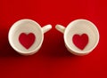 Two cups of coffee with hearts on red background. Royalty Free Stock Photo