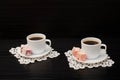 Two cups of coffee on the lace napkins and turkish dessert on a black background Royalty Free Stock Photo