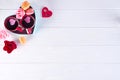 Two cups of coffee, macaroons with flowers in a box in the form of a heart on a white background. Valentine`s day Royalty Free Stock Photo