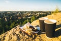 Two cups of coffee on the peak of the hill