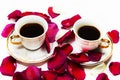 Two cups of coffee in the petals of roses Royalty Free Stock Photo