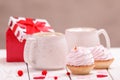 Two cups coffee and pink cream cupcakes on white wooden background. Concept Valentine`s Day, birthday, Wedding day Royalty Free Stock Photo