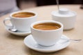 Two cups of coffee and sugar bowl on marble table Royalty Free Stock Photo