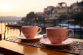 Two cups of coffee on a table of outdoor restaurant in small seaside town in Italy. Having breakfast coffee in Italian scenery on Royalty Free Stock Photo